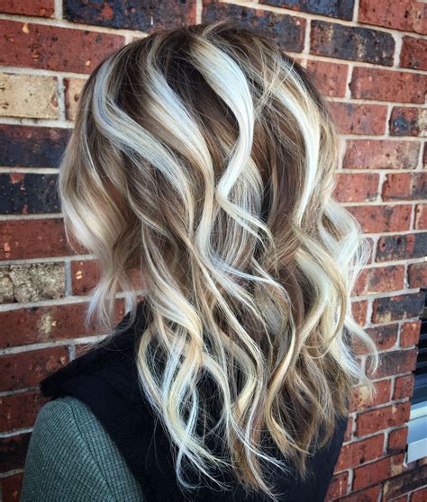 Contrast hair color is a real trend in 2024. . Icy blonde with dark lowlights